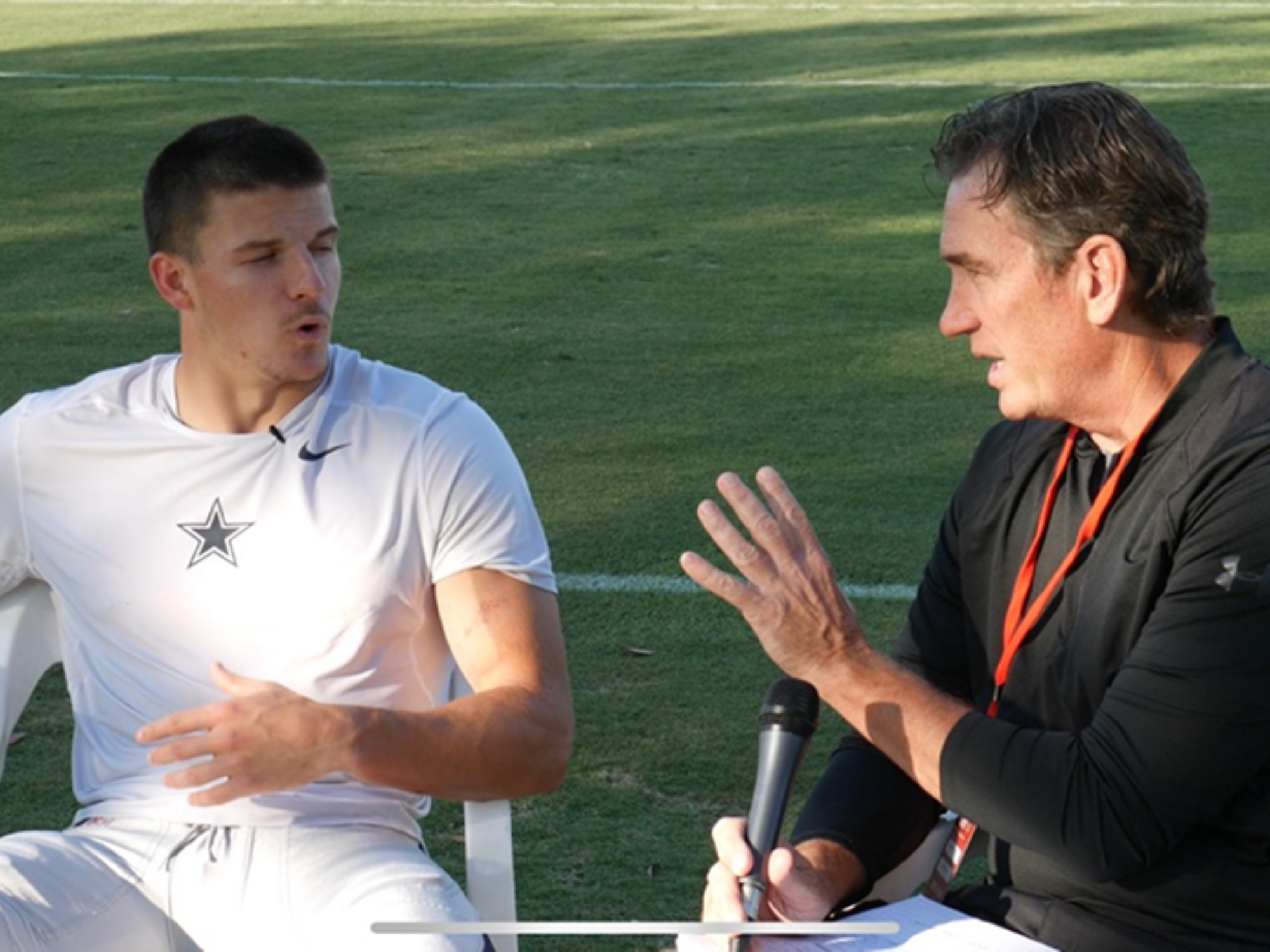 Brady Tinker interviewing NFL football player